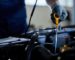 closeup-of-a-auto-repairman-checking-car-oil-in-a-workshop_637285-7638